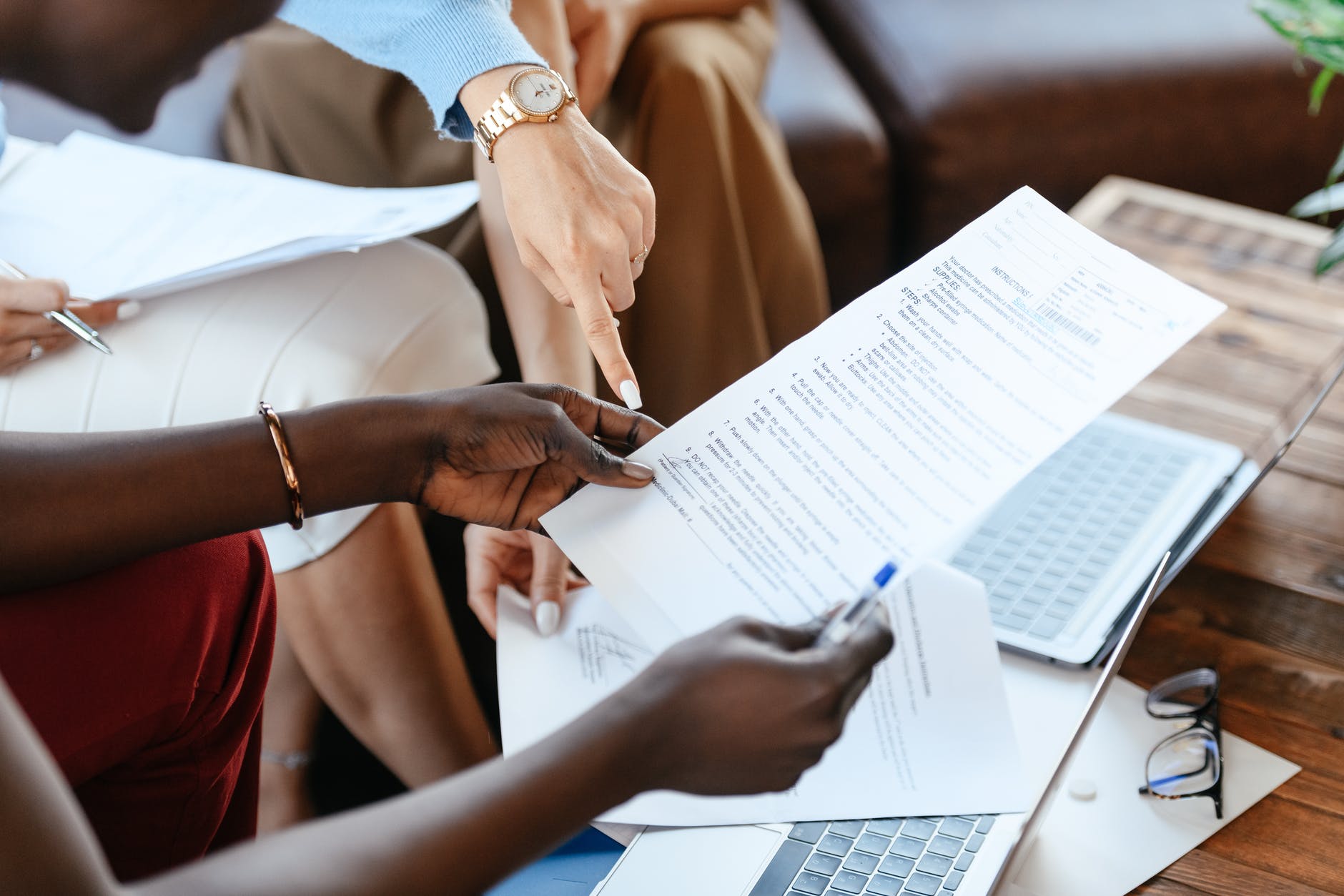pexels-photo-6457521 multiethnic businesswomen checking information in documents